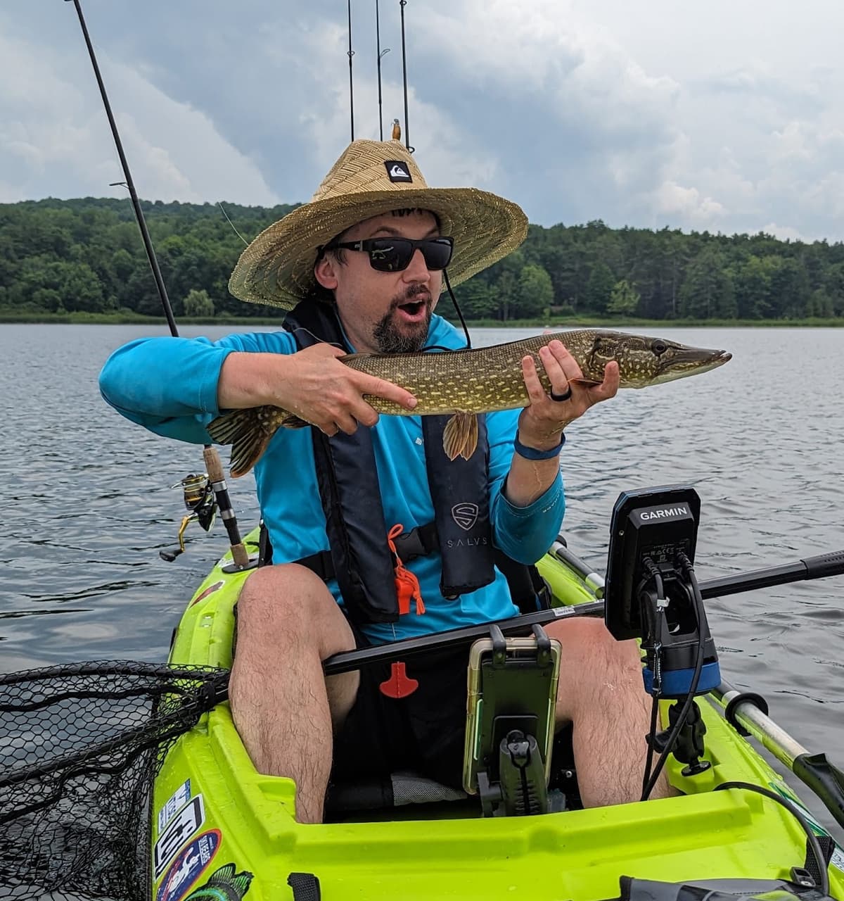 Mat with a nice pike in his bright green kayak