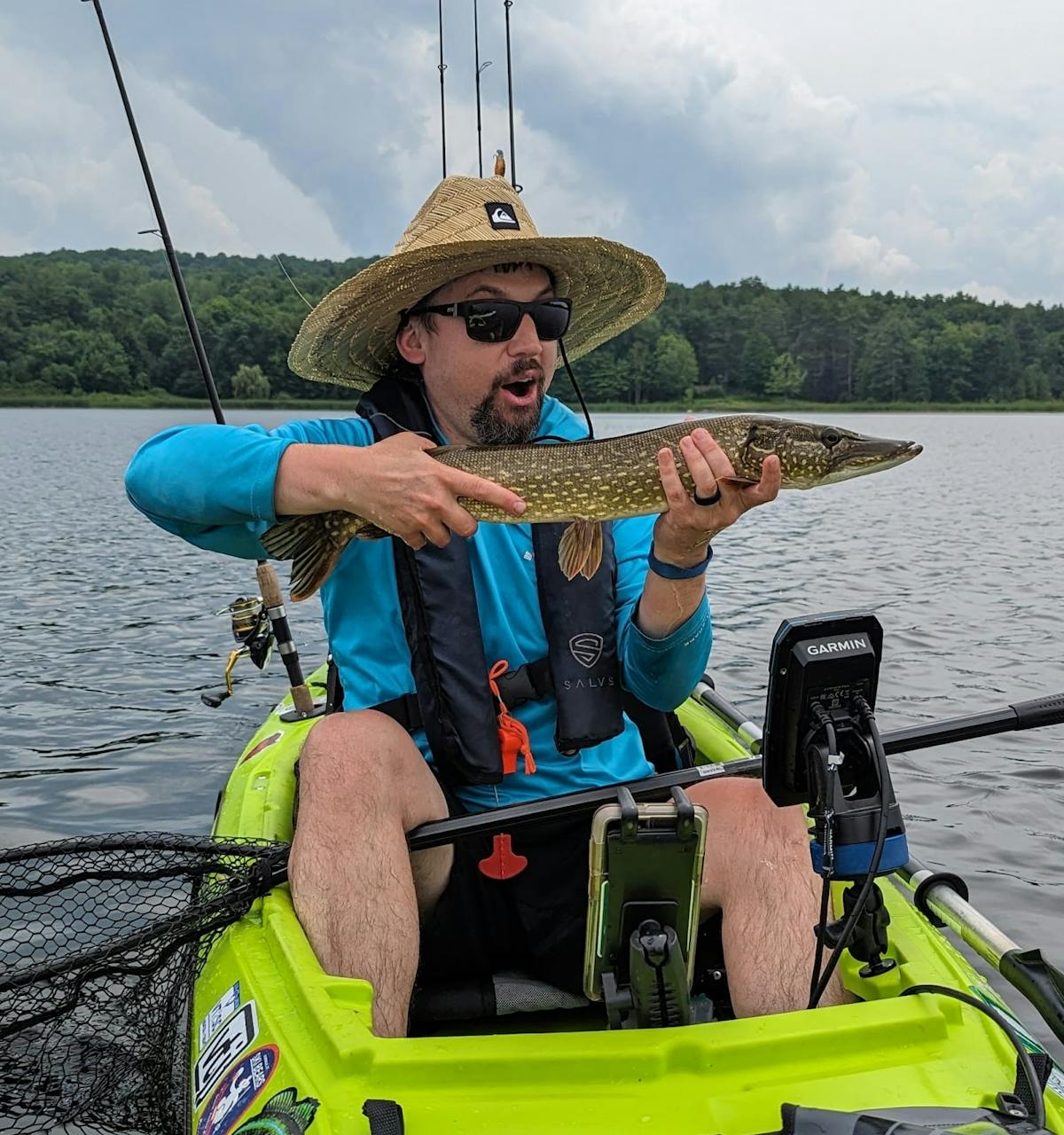Mat with a nice pike in his bright green kayak